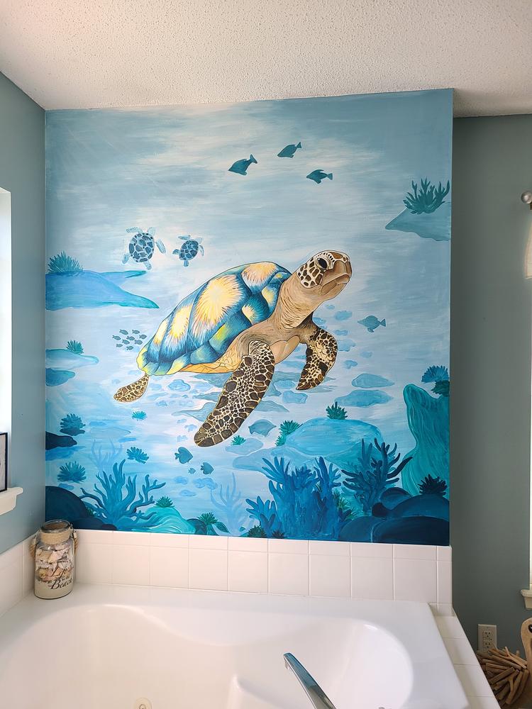 Hand-painted sea turtle mural above a bathtub